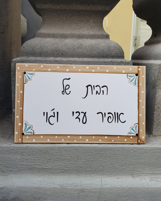 שלט לדלת כניסה עם מסגרת עץ טבעי וכיתוב אישי בעבודת יד